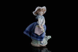 Lladro Figurine of a Young Girl with a Basket of Flowers.